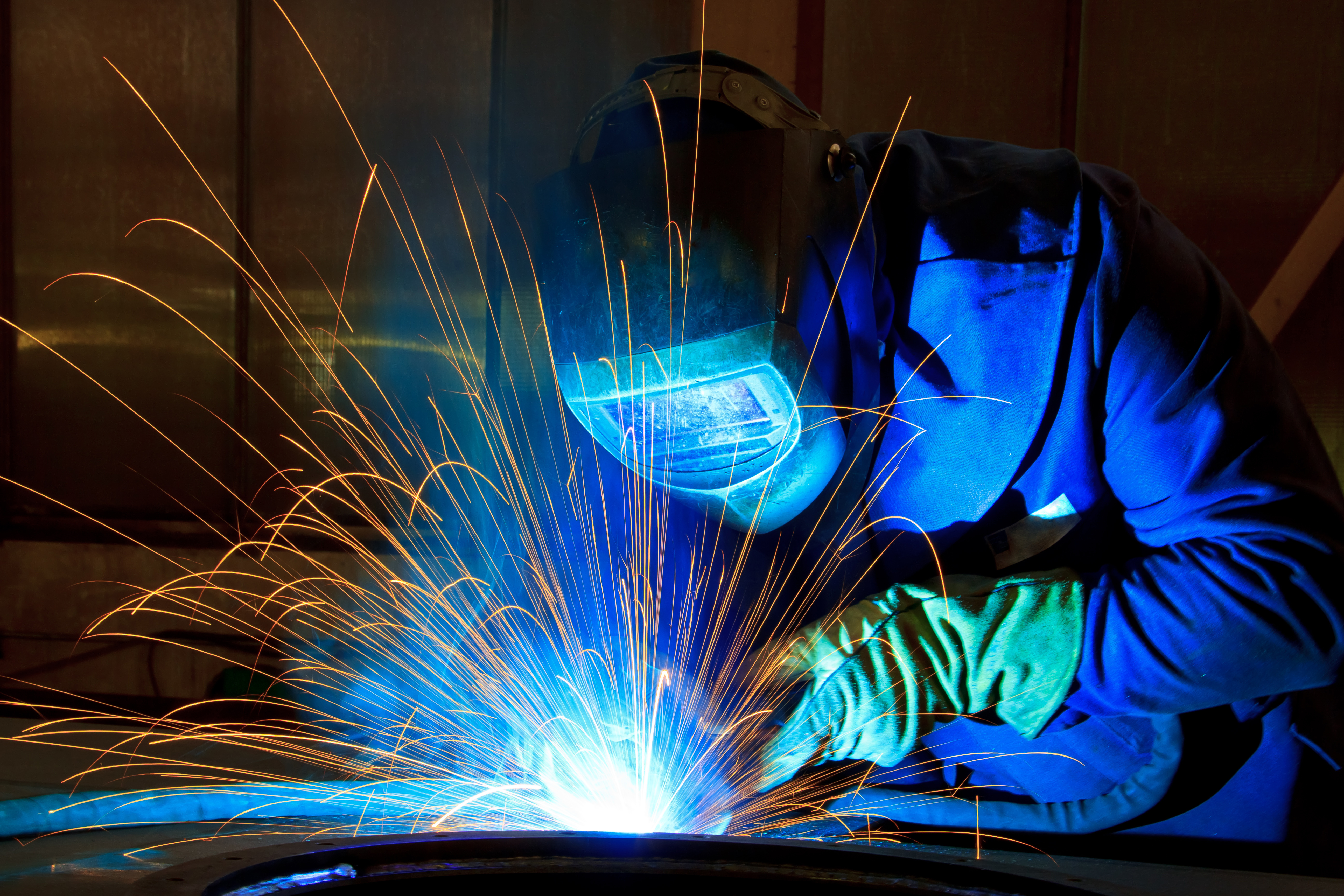 Welder using shield gases at an industrial facility